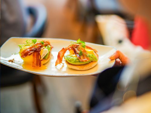 Plate of bacon and avocado on toasted bread served at Cibo