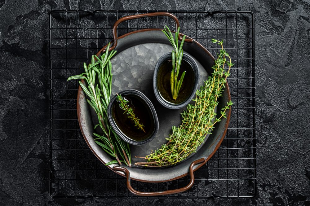 Fresh herbs with olive oil, top view.