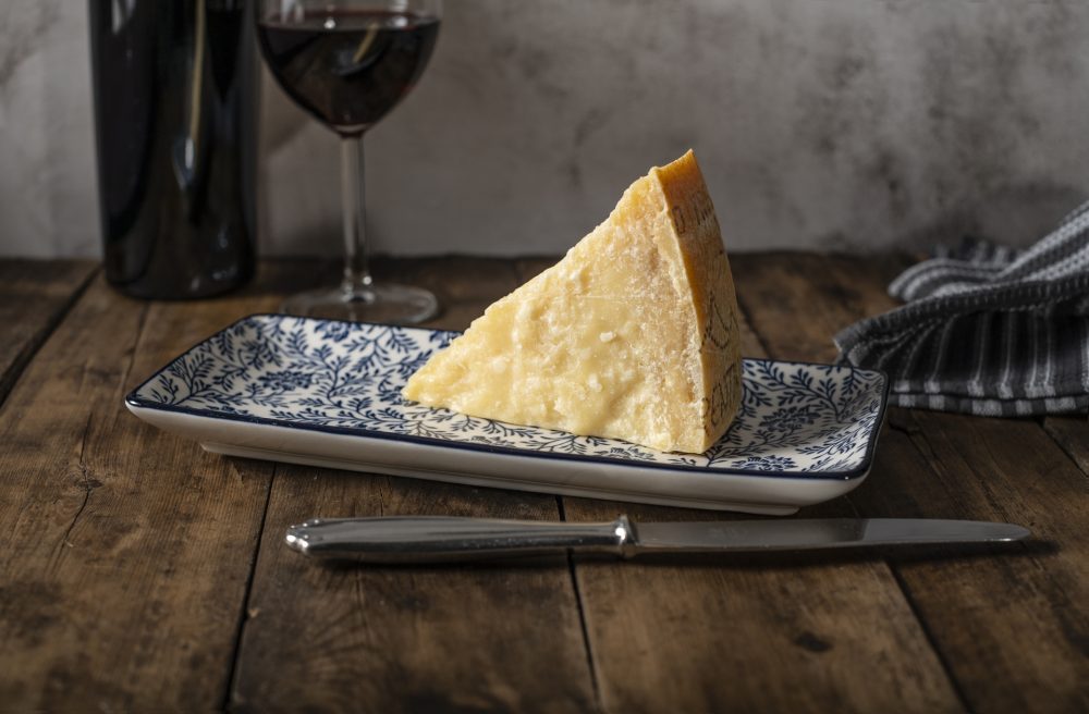 A wedge of Parmigiano Reggiano cheese.